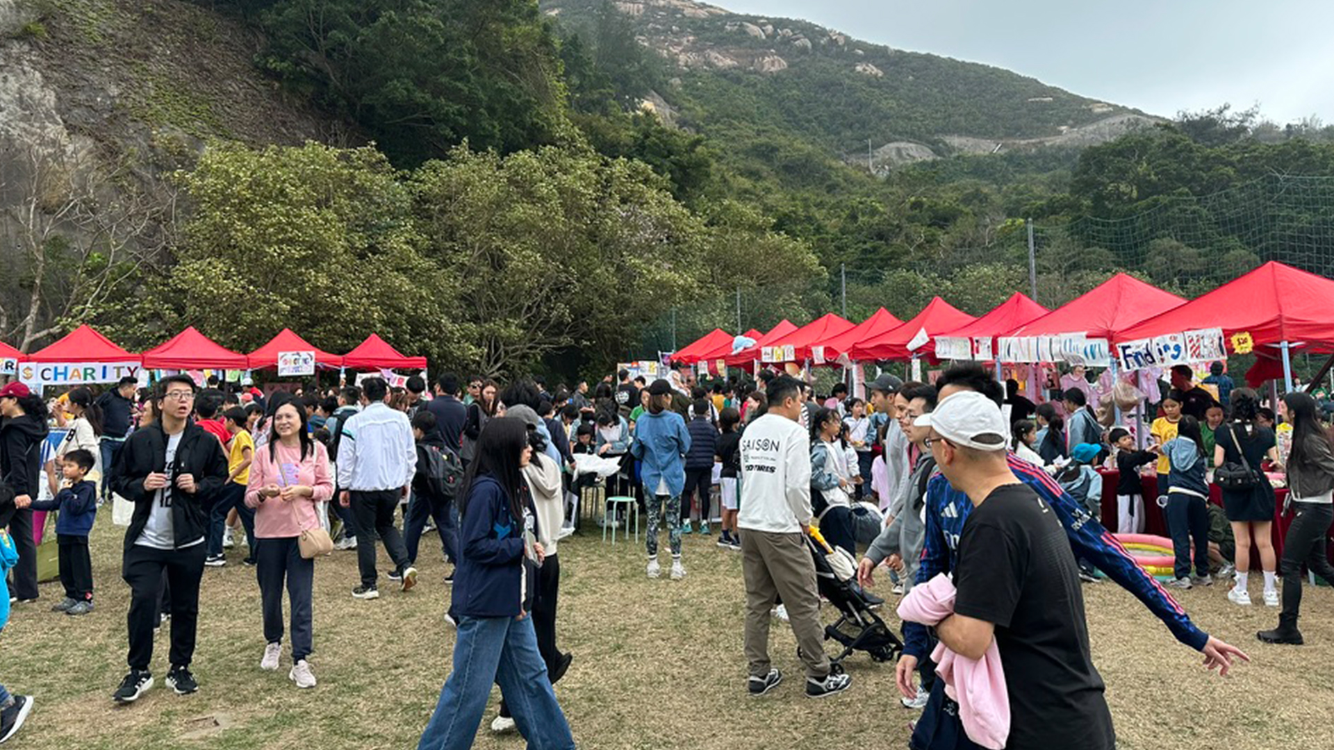 professional facilitators organizing a large scale tech workshop with neatly arranged hardware kits and focused participants